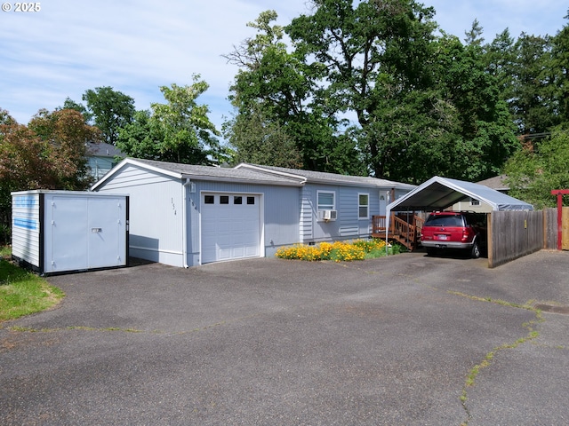 154 N 5th St, Saint Helens, OR 97051 - view of front facade featuring a carport, a garage, an outdoor structure, and crawl space
