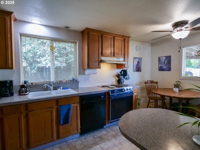154 N 5th St, Saint Helens, OR 97051 - kitchen featuring black dishwasher, a sink, under cabinet range hood, electric stove, and brown cabinets