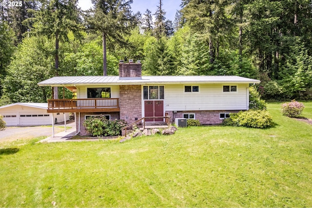112 Paine Rd, Castle Rock, WA 98611 - split foyer home with a chimney, a front lawn, a garage, cooling unit, and an outdoor structure