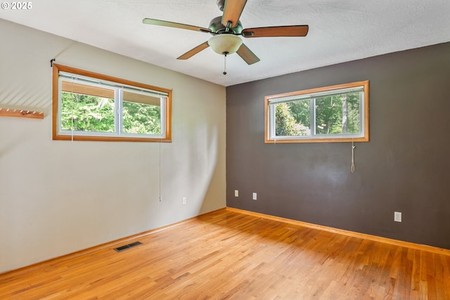 112 Paine Rd, Castle Rock, WA 98611 - spare room featuring wood finished floors, plenty of natural light, ceiling fan, and baseboards
