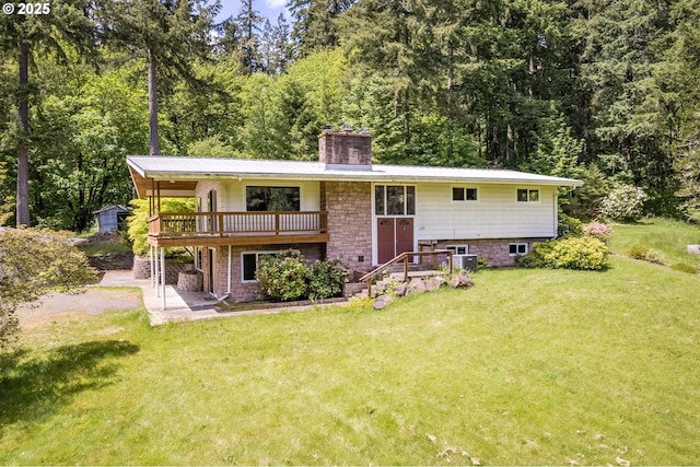 112 Paine Rd, Castle Rock, WA 98611 - back of house with a chimney, a lawn, a deck, a patio area, and cooling unit