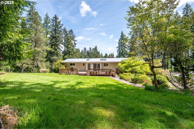 112 Paine Rd, Castle Rock, WA 98611 - back of property featuring a deck, a lawn, and metal roof