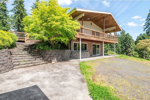 112 Paine Rd, Castle Rock, WA 98611 - rear view of house with a deck, stairs, and a patio area
