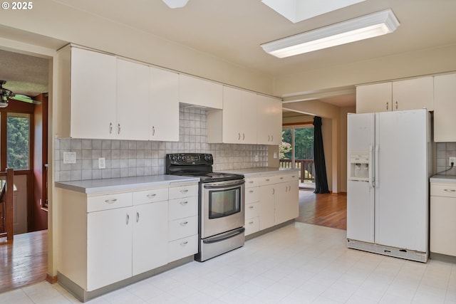 112 Paine Rd, Castle Rock, WA 98611 - kitchen with white refrigerator with ice dispenser, electric range, light countertops, and backsplash