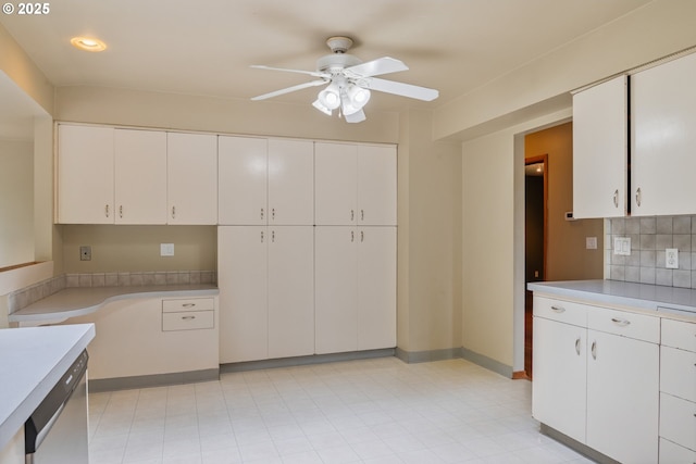 112 Paine Rd, Castle Rock, WA 98611 - kitchen with a ceiling fan, light countertops, stainless steel dishwasher, white cabinetry, and tasteful backsplash
