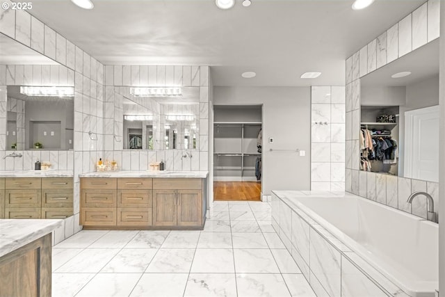 2193 NE 3rd Ave, Camas, WA 98607 - full bath featuring marble look tile flooring, vanity, a spacious closet, a garden tub, and recessed lighting