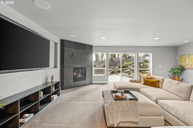 2193 NE 3rd Ave, Camas, WA 98607 - living area featuring carpet floors, a textured ceiling, recessed lighting, and a tile fireplace