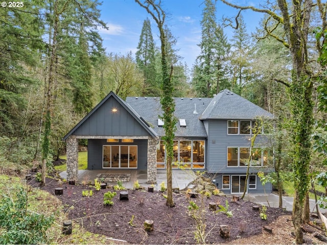 2193 NE 3rd Ave, Camas, WA 98607 - rear view of property with a patio, board and batten siding, roof with shingles, and stone siding