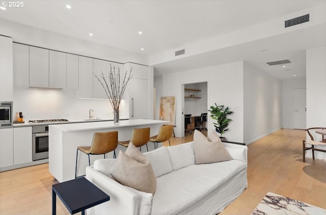 1150 NW Quimby St Unit 610, Portland, OR 97209 - living room featuring light wood finished floors and recessed lighting
