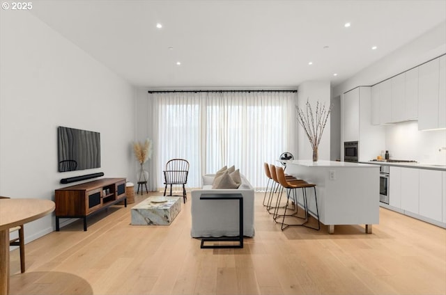 1150 NW Quimby St Unit 610, Portland, OR 97209 - living room with light wood-type flooring and recessed lighting