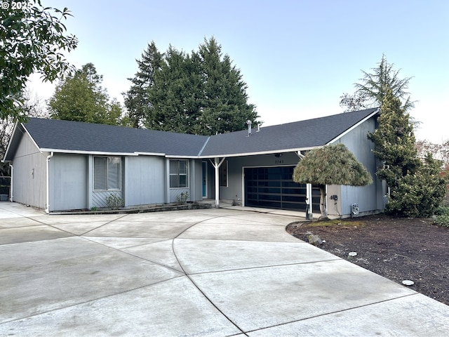 single story home featuring a garage and concrete driveway