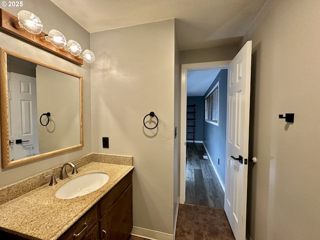 bathroom featuring baseboards and vanity