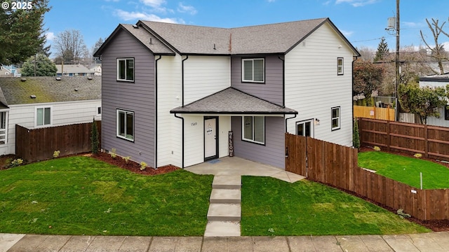 view of property featuring a patio area and a front lawn