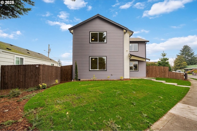 rear view of house featuring a yard