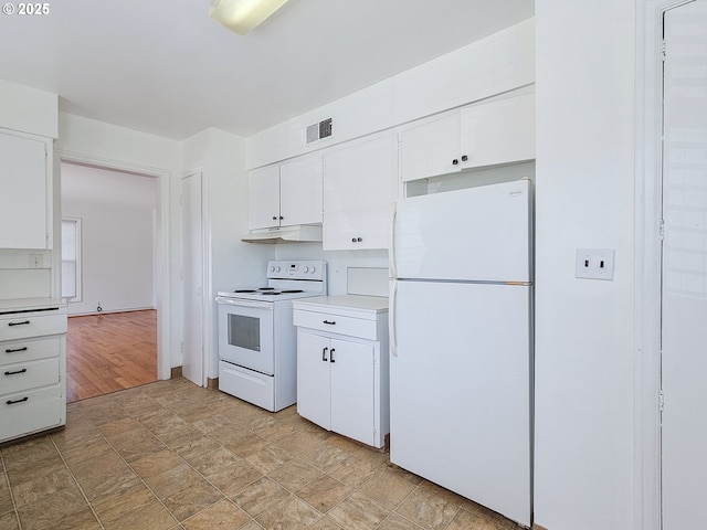 kitchen with visible vents, light countertops, white cabinets, under cabinet range hood, and white appliances