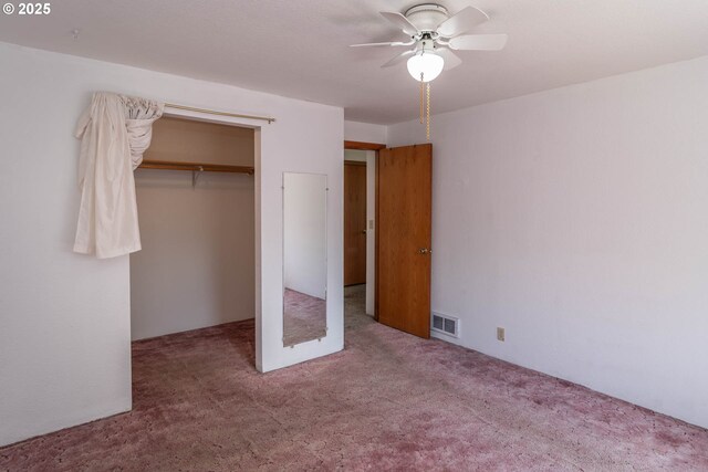 unfurnished bedroom featuring carpet, a closet, and ceiling fan
