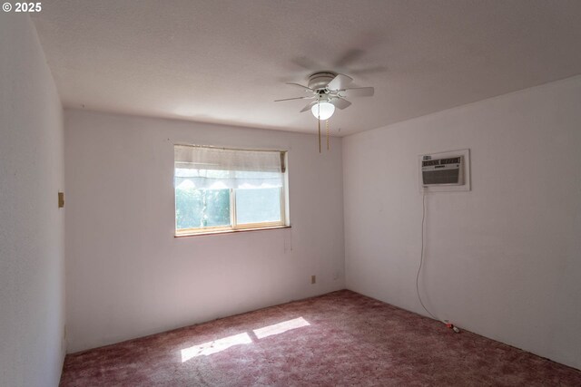 carpeted empty room featuring a wall mounted air conditioner and ceiling fan