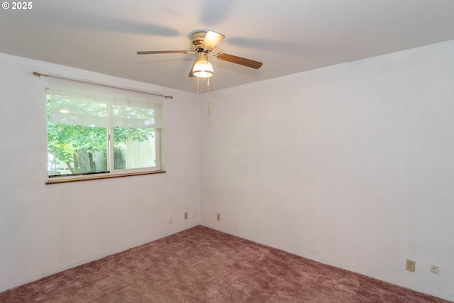 empty room featuring carpet floors and a ceiling fan