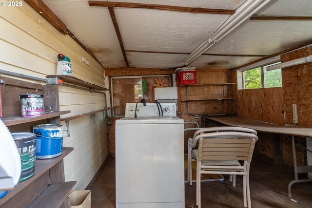 laundry area with washer / dryer and wooden walls
