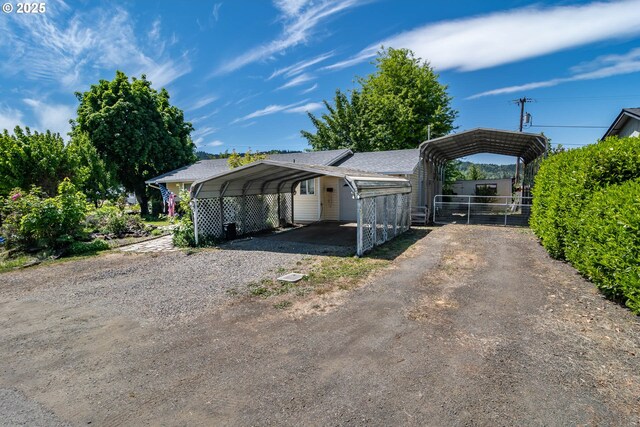 view of home's exterior featuring a carport and fence