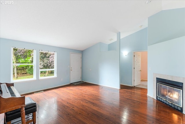 10406 NE 88th St, Vancouver, WA 98662 - unfurnished living room with lofted ceiling, wood finished floors, and a tiled fireplace