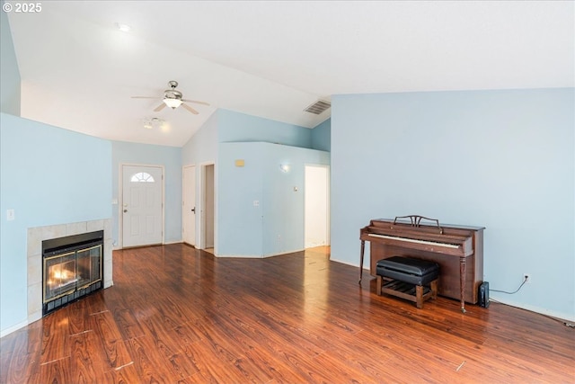 10406 NE 88th St, Vancouver, WA 98662 - living room featuring a ceiling fan, wood finished floors, vaulted ceiling, and a tiled fireplace