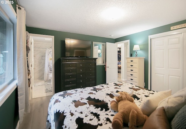 bedroom featuring a textured ceiling, a closet, and wood finished floors