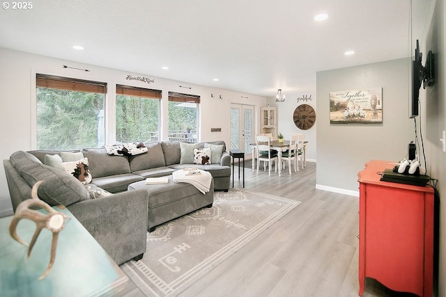 living room with baseboards, recessed lighting, and light wood-type flooring