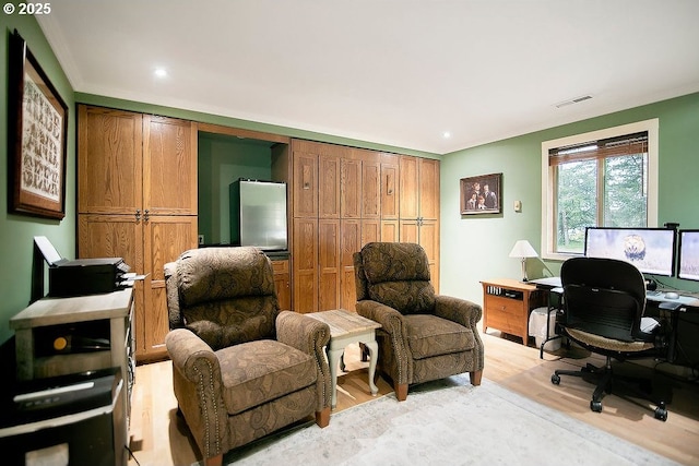 office featuring recessed lighting, ornamental molding, light wood finished floors, and visible vents