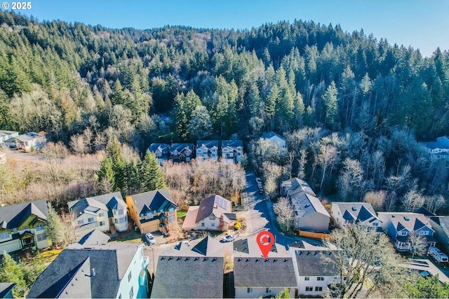 birds eye view of property with a residential view and a view of trees