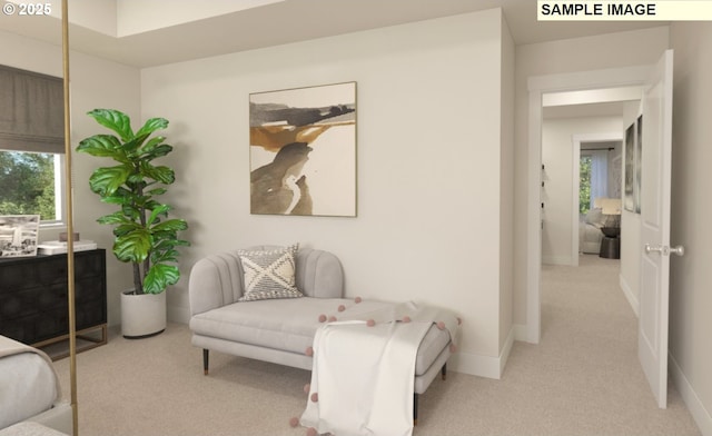 sitting room with light carpet, plenty of natural light, and baseboards