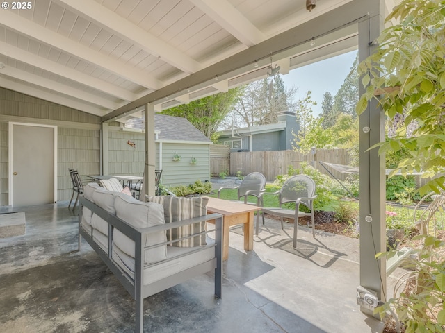 view of patio / terrace with an outdoor living space and fence