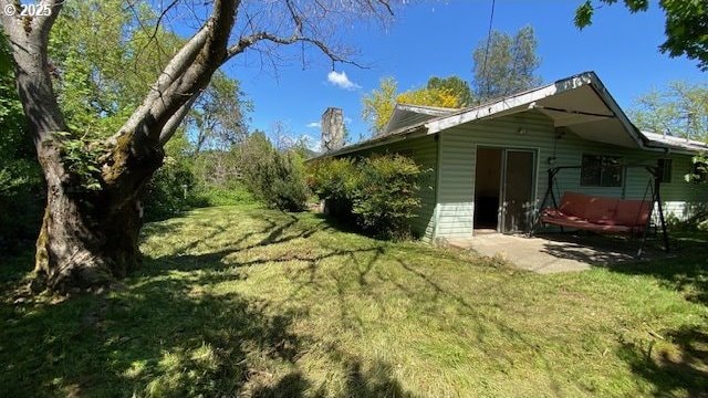 333 W Park St, Grants Pass, OR 97527 - view of side of property featuring a yard and a chimney