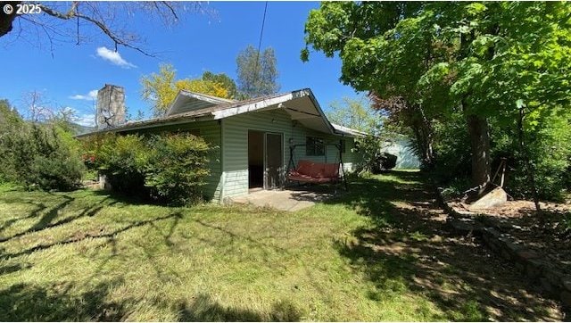333 W Park St, Grants Pass, OR 97527 - view of home's exterior featuring a lawn and a chimney