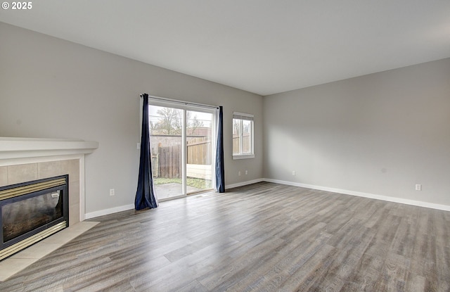 unfurnished living room featuring a fireplace and light hardwood / wood-style flooring