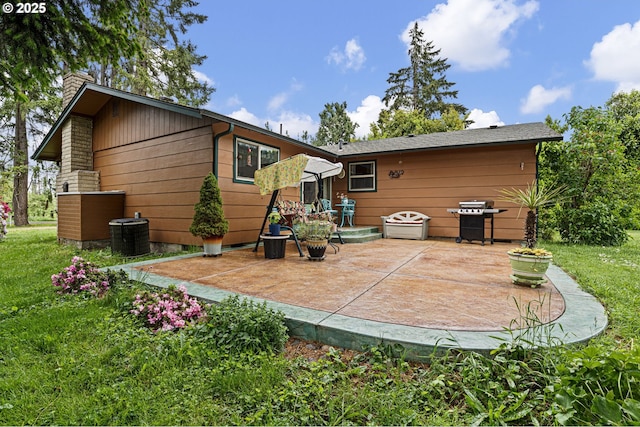 8157 Thurston Rd, Springfield, OR 97477 - back of house featuring a patio area, a chimney, central AC, and a lawn
