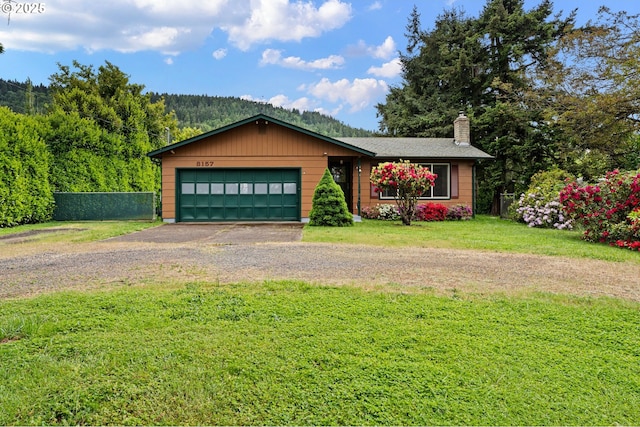 8157 Thurston Rd, Springfield, OR 97477 - view of front of home with dirt driveway, a chimney, and an attached garage