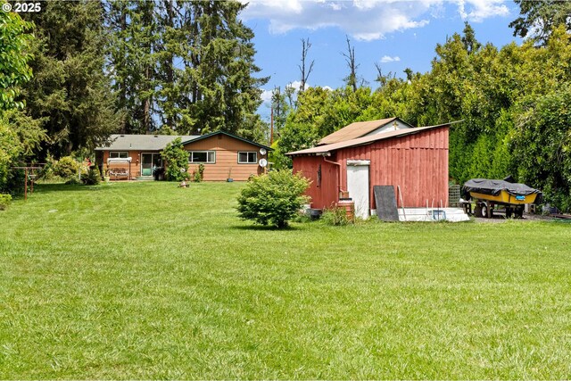 8157 Thurston Rd, Springfield, OR 97477 - view of green lawn with an outbuilding and view of wooded area