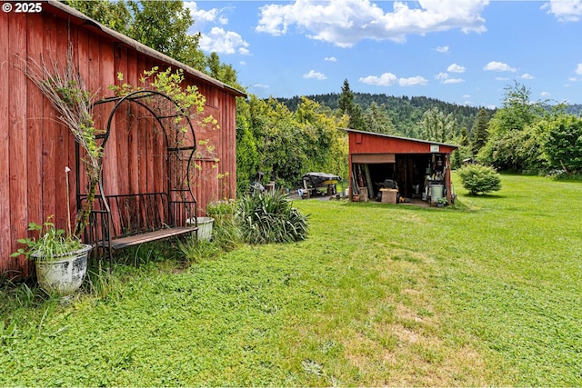 8157 Thurston Rd, Springfield, OR 97477 - view of green lawn with an outdoor structure, a view of trees, and an outbuilding