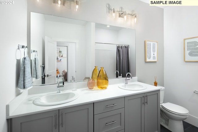 bathroom featuring vanity and toilet