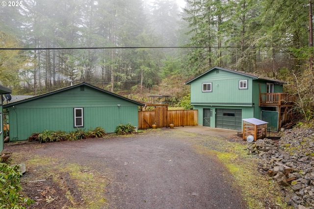 29536 Simmons Rd, Eugene, OR 97405 - view of side of home featuring driveway, a garage, and a forest view