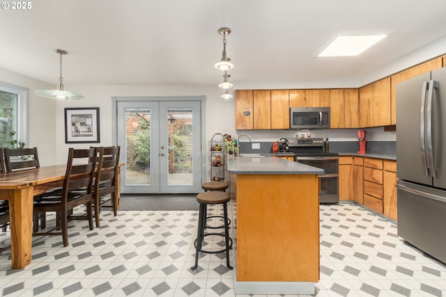 29536 Simmons Rd, Eugene, OR 97405 - kitchen featuring appliances with stainless steel finishes, a sink, healthy amount of natural light, and dark countertops