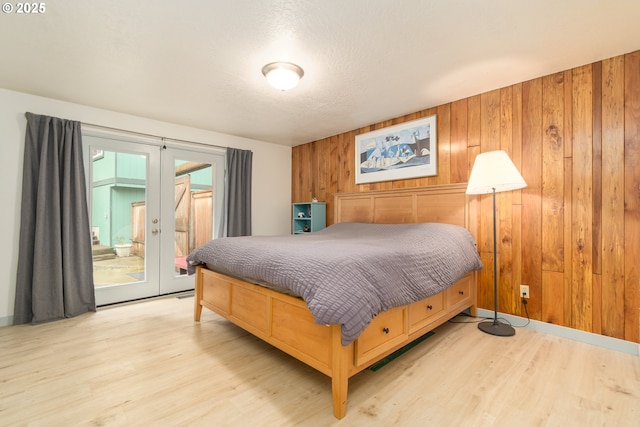 29536 Simmons Rd, Eugene, OR 97405 - bedroom with access to outside, french doors, wood walls, and light wood-style flooring