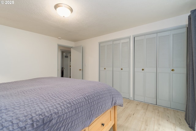 29536 Simmons Rd, Eugene, OR 97405 - bedroom featuring multiple closets and light wood-style floors