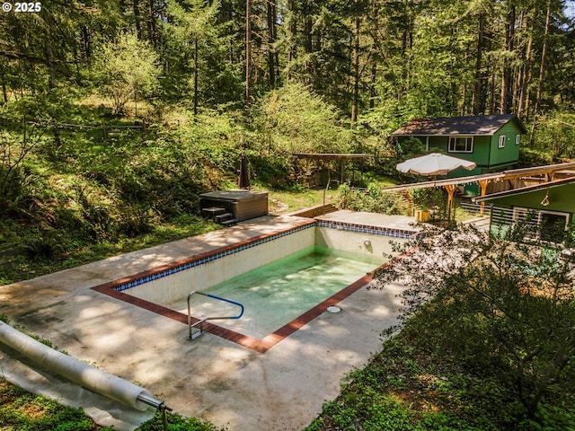 29536 Simmons Rd, Eugene, OR 97405 - view of swimming pool with an outdoor structure, an empty pool, a forest view, and a patio