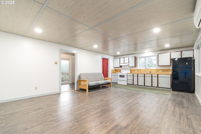 29536 Simmons Rd, Eugene, OR 97405 - sitting room featuring wood finished floors, wood ceiling, baseboards, recessed lighting, and an AC wall unit