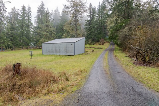 29536 Simmons Rd, Eugene, OR 97405 - view of dirt / gravel road with a pole building and a forest view