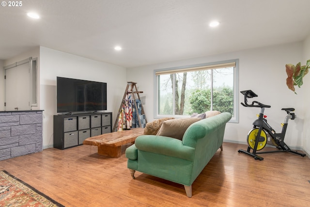 living room featuring light wood-style flooring, baseboards, and recessed lighting