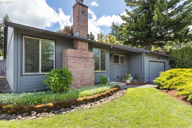 2416 SW 23rd Cir, Troutdale, OR 97060 - view of property exterior featuring a garage, a chimney, and a yard