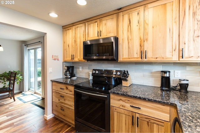 2416 SW 23rd Cir, Troutdale, OR 97060 - kitchen featuring stainless steel microwave, black range with electric stovetop, backsplash, wood finished floors, and recessed lighting